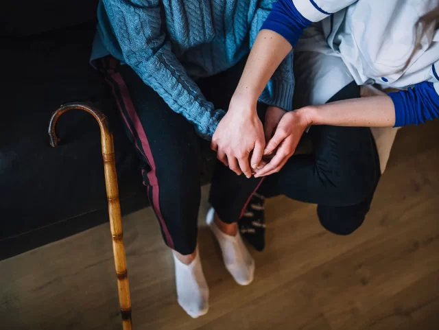 retirement-home-concept-with-nurse-and-woman-holding-hands